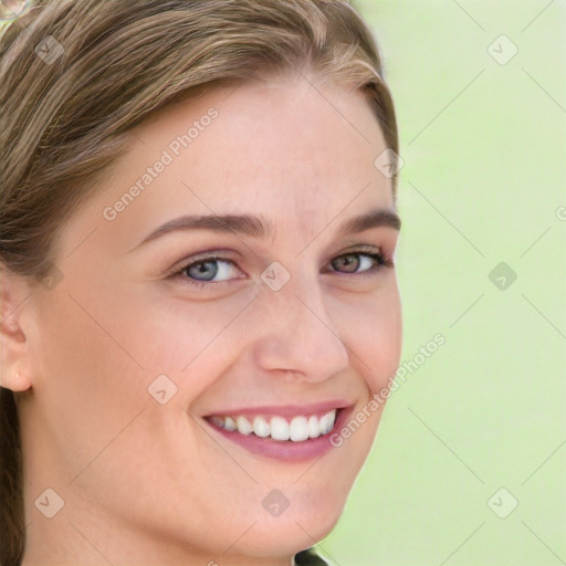 Joyful white young-adult female with long  brown hair and blue eyes