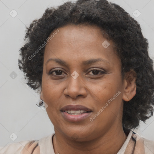 Joyful black adult female with short  brown hair and brown eyes