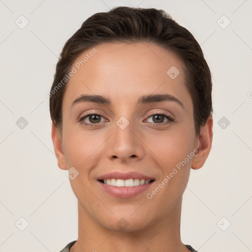 Joyful white young-adult female with short  brown hair and brown eyes