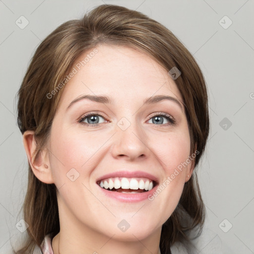 Joyful white young-adult female with medium  brown hair and blue eyes