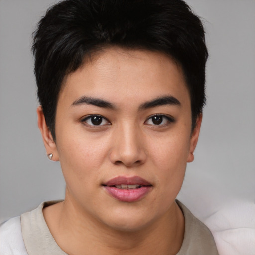 Joyful asian young-adult female with short  brown hair and brown eyes