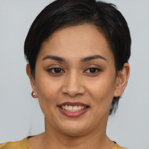 Joyful latino young-adult female with short  brown hair and brown eyes