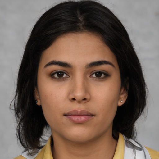 Neutral latino young-adult female with medium  brown hair and brown eyes