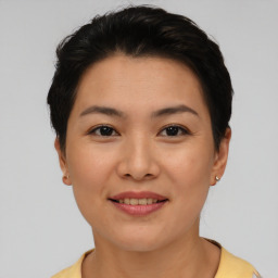 Joyful asian young-adult female with short  brown hair and brown eyes