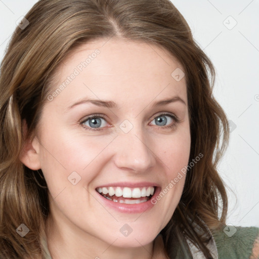 Joyful white young-adult female with long  brown hair and blue eyes