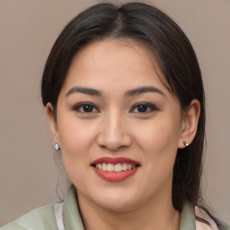 Joyful latino young-adult female with medium  brown hair and brown eyes