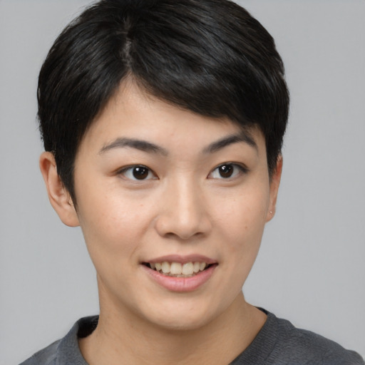 Joyful asian young-adult female with short  brown hair and brown eyes