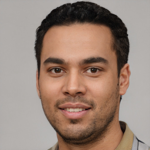 Joyful white young-adult male with short  black hair and brown eyes