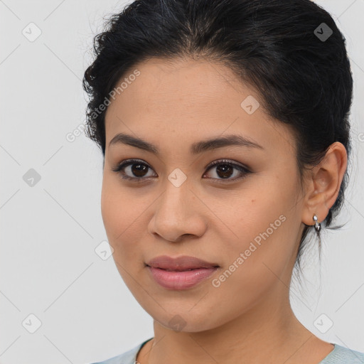 Joyful latino young-adult female with medium  brown hair and brown eyes