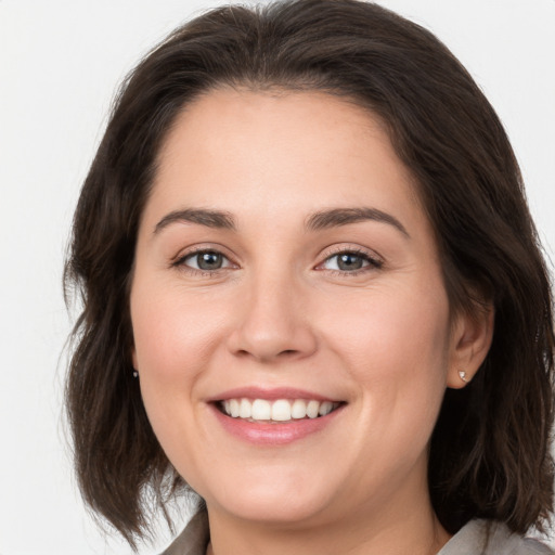 Joyful white young-adult female with medium  brown hair and brown eyes