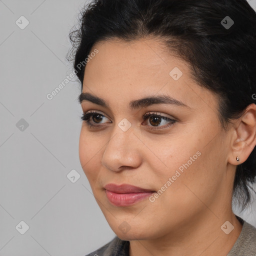 Joyful latino young-adult female with medium  brown hair and brown eyes