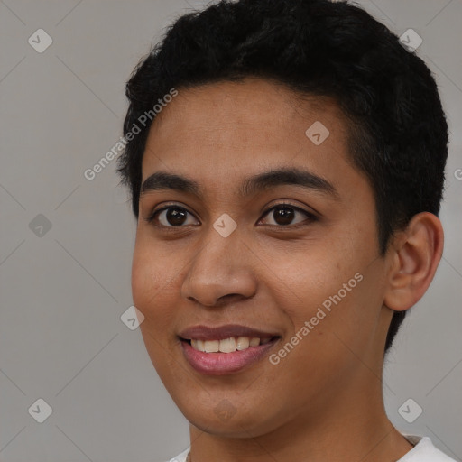 Joyful black young-adult female with short  black hair and brown eyes