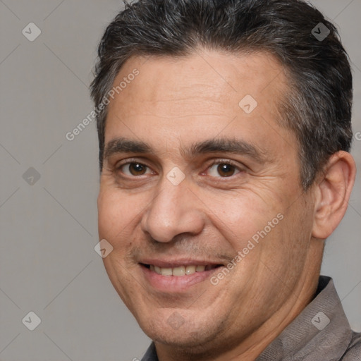 Joyful white adult male with short  brown hair and brown eyes