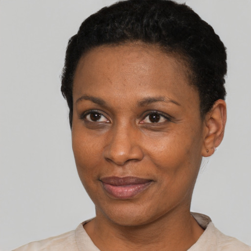 Joyful black young-adult female with short  black hair and brown eyes