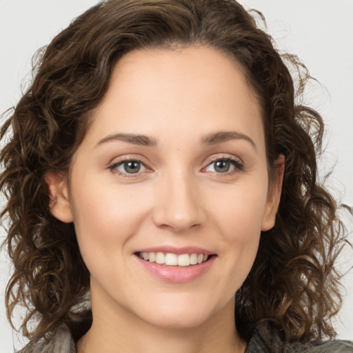 Joyful white young-adult female with long  brown hair and green eyes