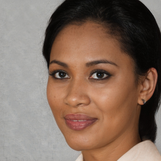 Joyful black young-adult female with short  black hair and brown eyes