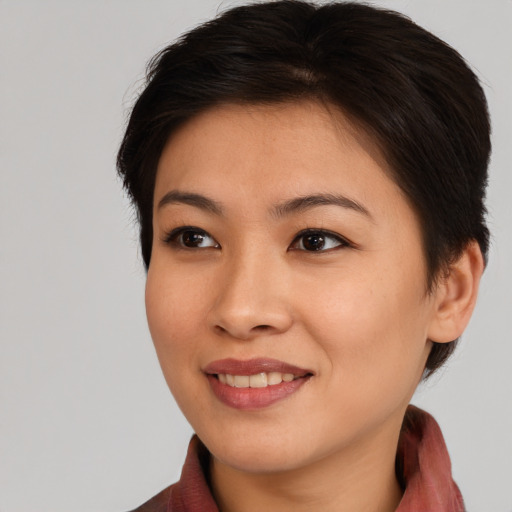 Joyful asian young-adult female with medium  brown hair and brown eyes