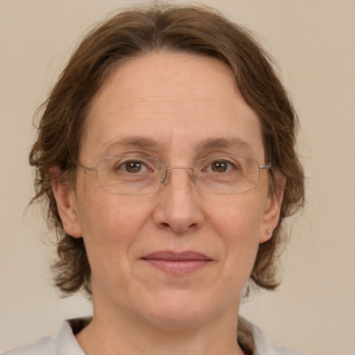 Joyful white middle-aged female with medium  brown hair and green eyes