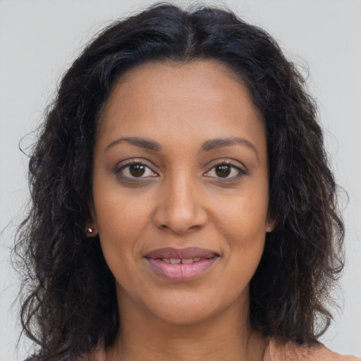 Joyful latino young-adult female with long  brown hair and brown eyes