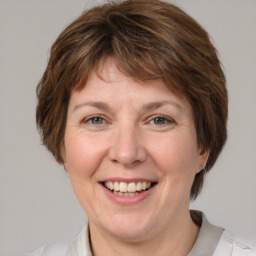 Joyful white adult female with medium  brown hair and grey eyes