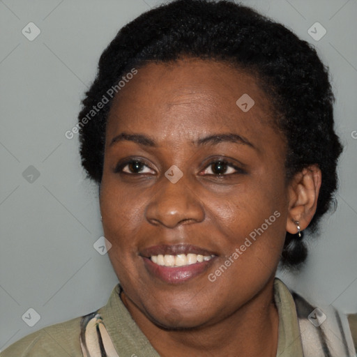 Joyful black adult female with short  brown hair and brown eyes