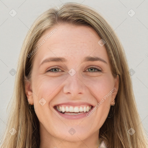 Joyful white young-adult female with long  brown hair and green eyes