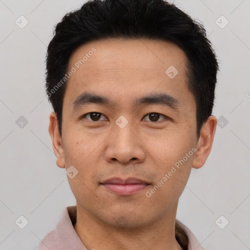 Joyful asian young-adult male with short  black hair and brown eyes