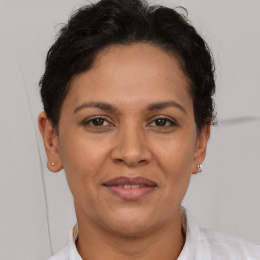 Joyful latino adult female with short  brown hair and brown eyes