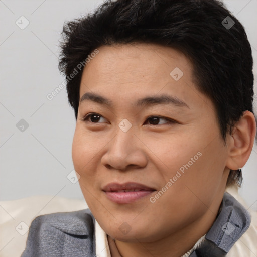 Joyful asian young-adult male with short  brown hair and brown eyes
