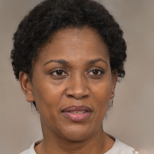 Joyful black adult female with short  brown hair and brown eyes