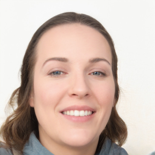 Joyful white young-adult female with long  brown hair and blue eyes