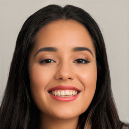 Joyful latino young-adult female with long  black hair and brown eyes