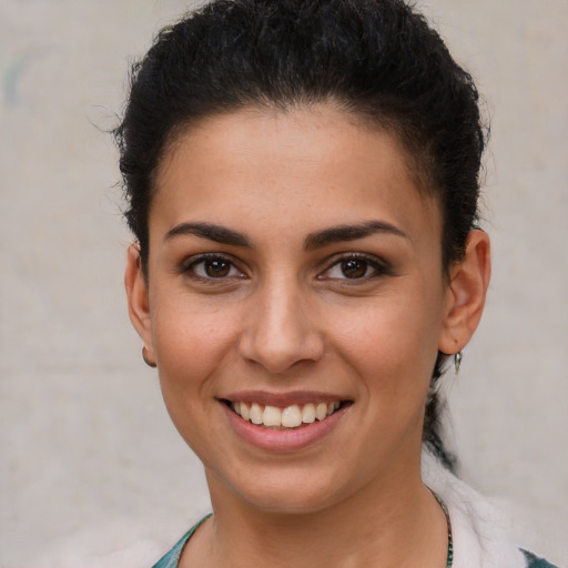 Joyful white young-adult female with short  brown hair and brown eyes