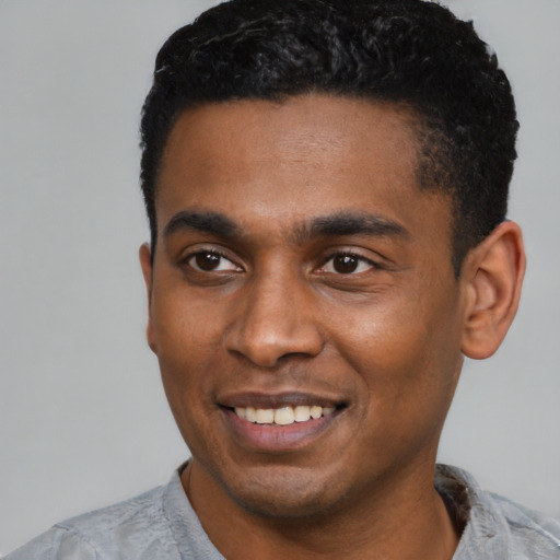 Joyful latino young-adult male with short  black hair and brown eyes