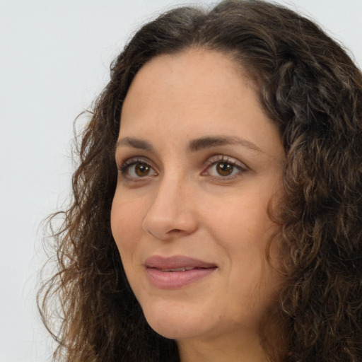 Joyful white adult female with long  brown hair and brown eyes