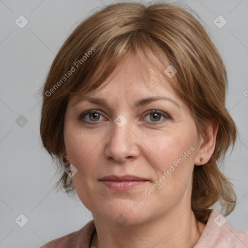 Joyful white adult female with medium  brown hair and grey eyes