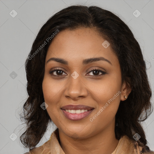 Joyful black young-adult female with long  brown hair and brown eyes