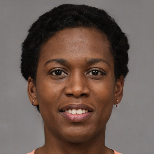 Joyful black young-adult female with short  black hair and brown eyes