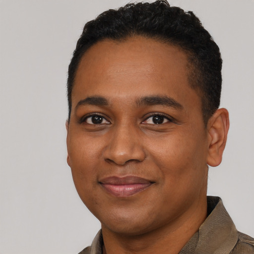 Joyful black young-adult male with short  black hair and brown eyes