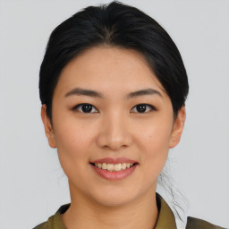 Joyful asian young-adult female with medium  black hair and brown eyes