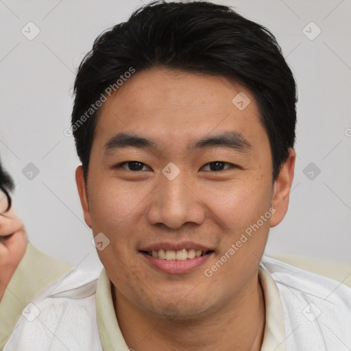 Joyful asian young-adult male with short  black hair and brown eyes