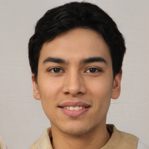 Joyful latino young-adult male with short  black hair and brown eyes