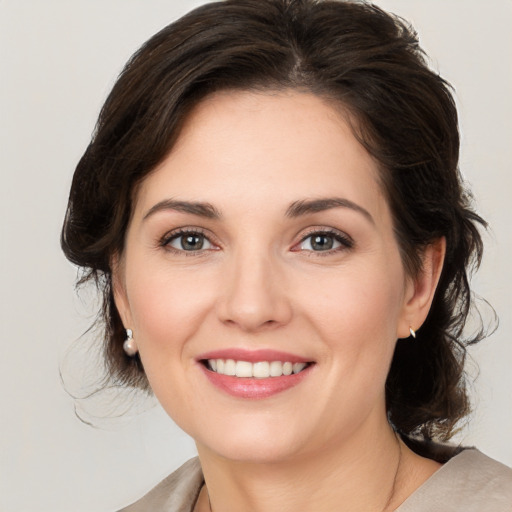 Joyful white young-adult female with medium  brown hair and brown eyes