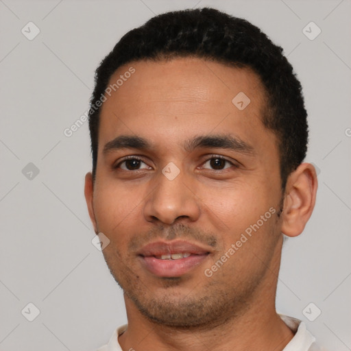 Joyful latino young-adult male with short  black hair and brown eyes