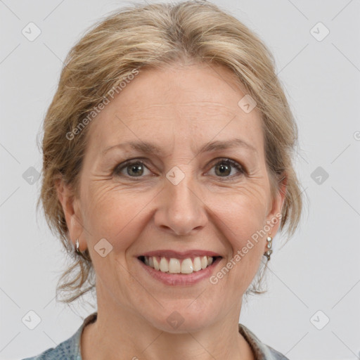 Joyful white adult female with medium  brown hair and grey eyes