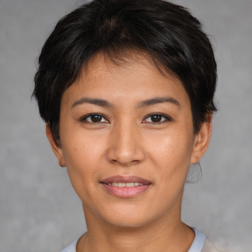 Joyful asian young-adult female with short  brown hair and brown eyes