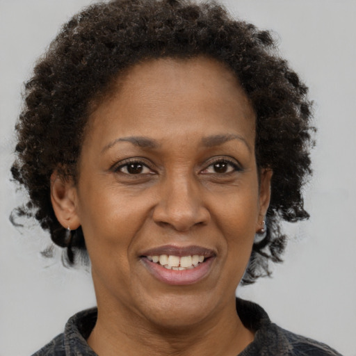 Joyful black adult female with medium  brown hair and brown eyes