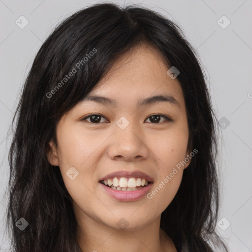 Joyful asian young-adult female with long  brown hair and brown eyes