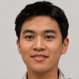 Joyful asian young-adult male with short  black hair and brown eyes