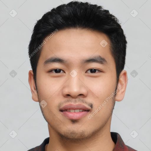 Joyful asian young-adult male with short  black hair and brown eyes